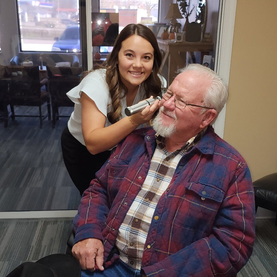A specialist fitting a patient for custom hearing protection